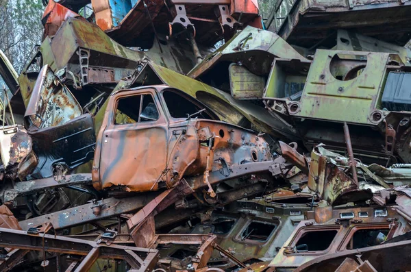 Piles of old cars in scrap metal yard ready for recycling, close-up