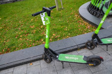 Rental E-wings electric scooter parked at the street. eco alternative transport concept