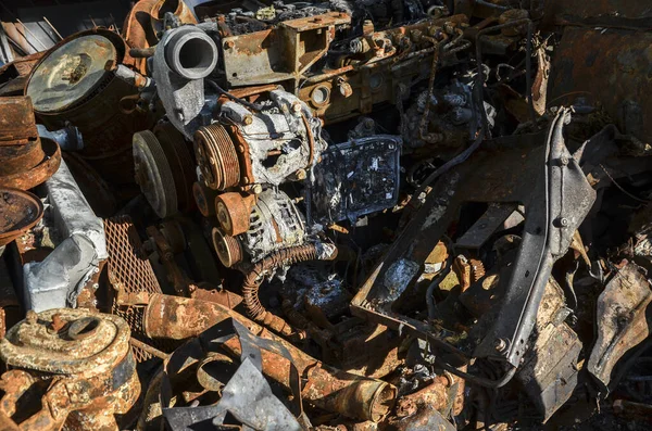 Close-up of burnt rusty engine in russian military vehicle after combat strike