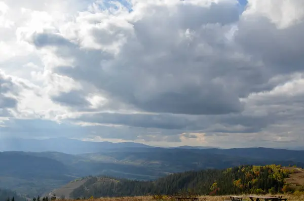 Sun Rays Shine Clouds Picturesque Mountains Covered Colorful Forests Autumn — Stock Fotó