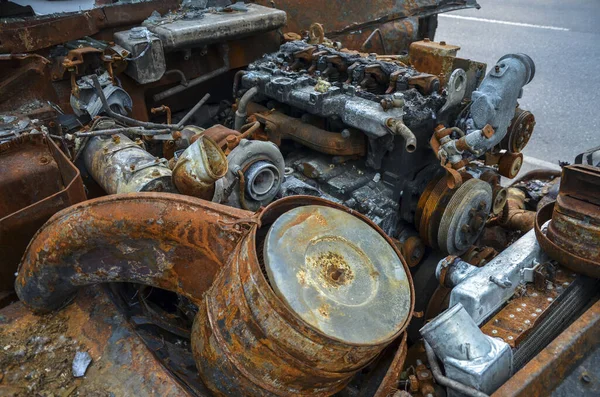 Close-up of burnt rusty engine in russian military vehicle after combat strike
