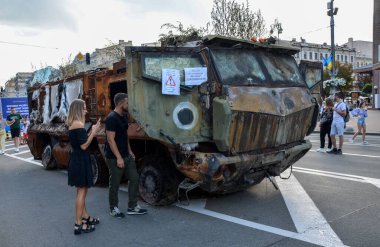 People walk past destroyed russian military equipment and take pictures on Khreshchatyk Street in the center of Kyiv, the capital of Ukraine.