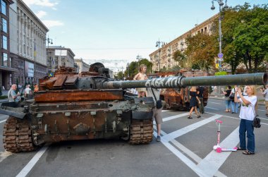 People walk past destroyed russian military equipment and take pictures on Khreshchatyk Street in the center of Kyiv, the capital of Ukraine.