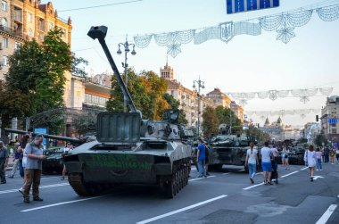 People walk along Khreshchatyk street in Kyiv during an exhibition of russian military equipment destroyed by Ukrainian forces