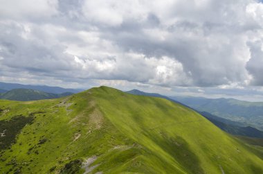 Scenic alpine landscape with mountain scenery with vivid green mountainside, hiking travel concept, conquer the top of the mountains. Carpathians, Ukraine