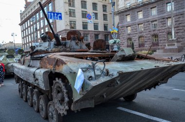 People visit an exhibition of destroyed Russian military vehicles and weapons, dedicated to the upcoming country's Independence Day 