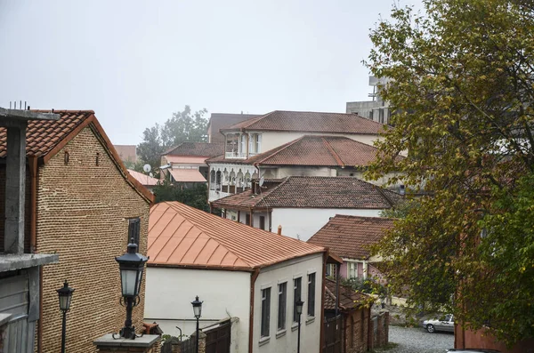 Wooden balconies and tiled roofs on city street in medieval town Sighnaghi in Alazani Valley, Kakheti region of Georgia