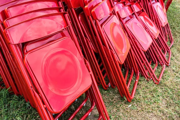 Een Stapel Rode Klapstoelen Het Veld — Stockfoto