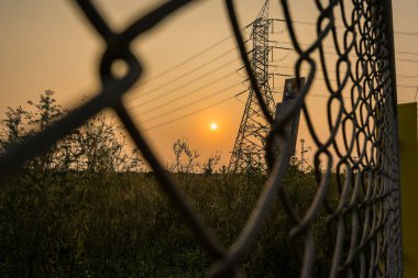 Güneşin doğuşunu görmek için tel örgülerin arasından bakıyorum..