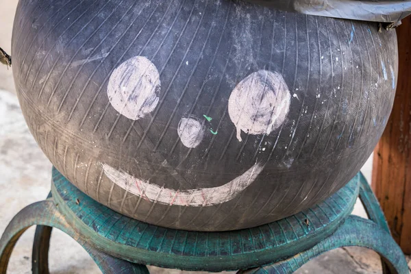Black trash smile made of truck tires.