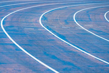 background of blue track for running competition at stadium, focus on center.