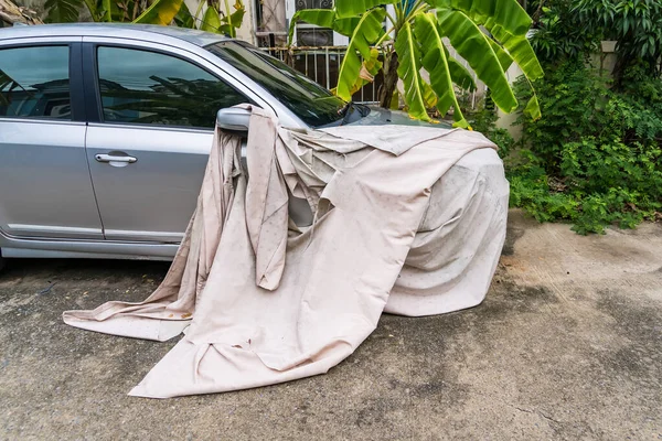 Bangkok, Thailand- July,19, 2022 : A covered car in the street.