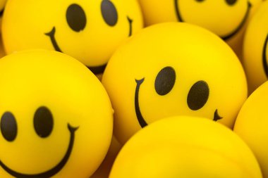 Happy faces ball on yellow background, smiling background.