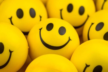 Happy faces ball on yellow background, smiling background.