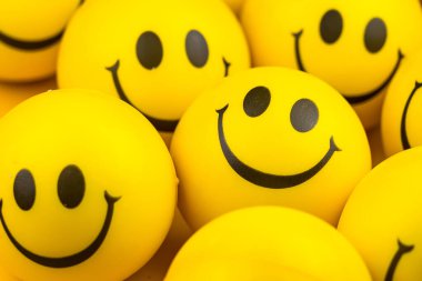 Happy faces ball on yellow background, smiling background. clipart