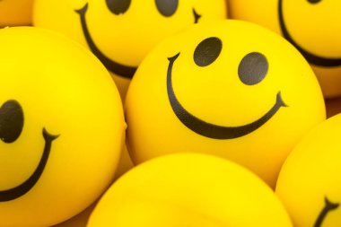 Happy faces ball on yellow background, smiling background.
