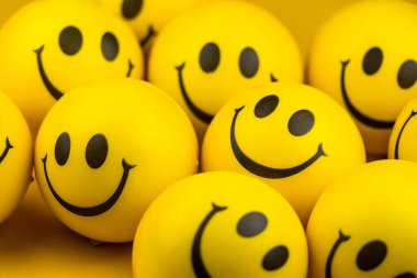 Happy faces ball on yellow background, smiling background.