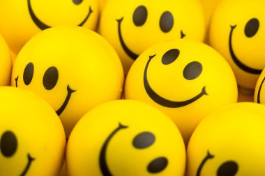 Happy faces ball on yellow background, smiling background.
