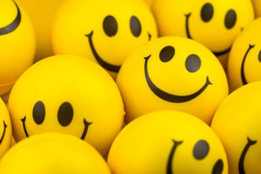 Happy faces ball on yellow background, smiling background.