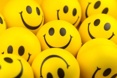 Happy faces ball on yellow background, smiling background.