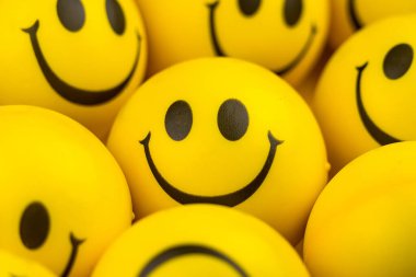 Happy faces ball on yellow background, smiling background.