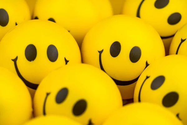 Happy faces ball on yellow background, smiling background.