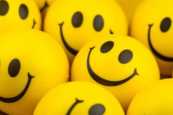 Happy faces ball on yellow background, smiling background.