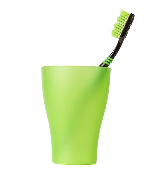 Toothbrush. Isolate on a white background. Green glass with a toothbrush. — Stock Photo, Image