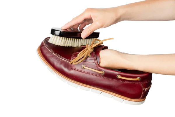 Leather shoe cleaning. Shoe restoration. Shoe care. Polishing shoes with a shoe brush. High quality photo