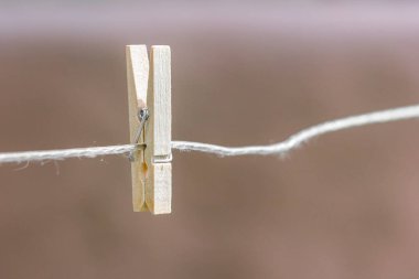 Wooden clothespin on an empty clothesline. High quality photo