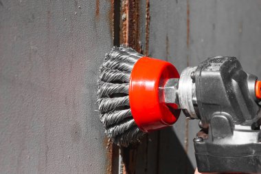 Removing rust from metal. Wire brush on an angle grinder. Cleaning of metal from corrosion. High quality photo