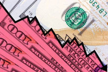 A line chart with a downtrend on the background of dollar bills. Stock market decline. dollar inflation. The fall of the dollar. World crisis. High quality photo
