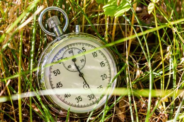 Mechanical stopwatch in the grass. Time measurement. High quality photo