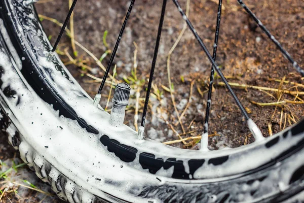 Cleaning bicycle wheels. Bicycle care. Bicycle tire in foam. Bike wash. High quality photo