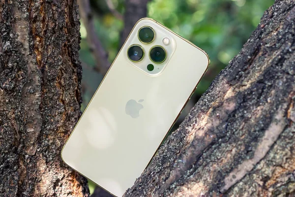 UKRAINE, DNEPR - JULY 25, 2022: smartphone Apple Iphone 13 Pro on the tree. Cameras in apple iphone 13 pro. High quality photo