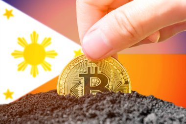 Legalization of bitcoins in the Philippines. Landing bitcoin in the ground on the background of the flag of the Philippines. Philippines - investment in cryptocurrency. High quality photo