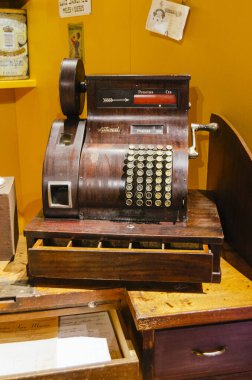 antique wooden store cashier with yellow background on a wooden table