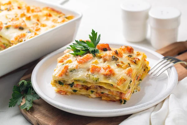 Lasagna with salmon fish, zucchini, bechamel sauce, parmesan cheese and leek.  Baked in an oven italian pasta made of flat sheets.