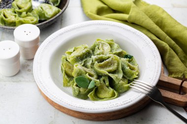 Tortelloni  or tortelli Balanzoni - italian green pasta with Spinach and Ricotta cheese filling, with butter and sage.
