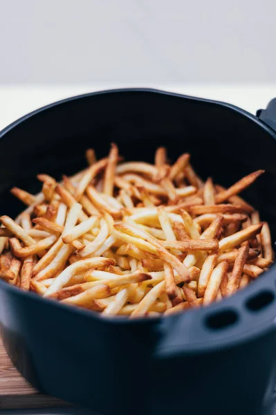 Air fryer with french fries on the worktop — Stock Photo, Image
