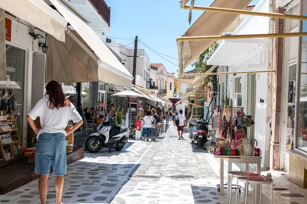 Tinos, Greece: July 17, 2022: City centre and streets of village of Tinos with Cycladic houses and shops on Tinos island, Cyclades, Greece
