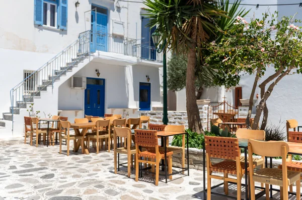 City centre and streets of village of Tinos with Cycladic houses, cafe and shops on Tinos island, Cyclades, Greece