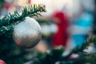 Christmas and New Year time, amazing Xmas decorations on pine trees with real snow, blurred background