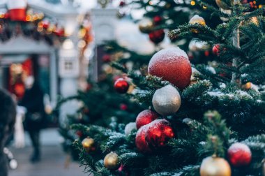 Christmas and New Year time, amazing Xmas decorations on pine trees with real snow, blurred background