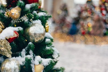 Christmas and New Year time, amazing Xmas decorations on pine trees with real snow, blurred background