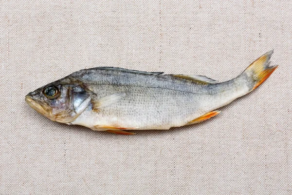 Dried fish on the wintage burlap close-up. — Stock Photo, Image