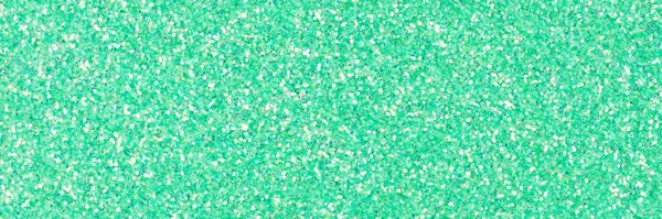 Perfect holographic glitter texture for project design work, background in light green tone. High resolution photo.