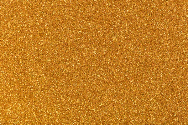 Shiny gold glitter background, new texture for elegant style. Abstract Christmas twinkled bright bokeh defocused and Falling stars. Sparkling lights festive background with texture.