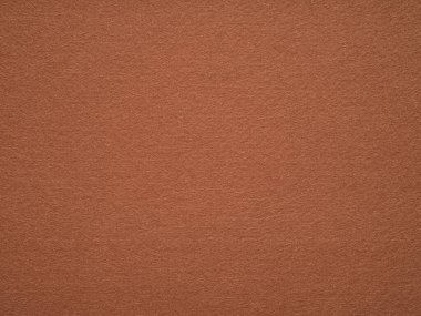 Doğal açık kahverengi keçeli kumaş. Sanat ve kırtasiye malzemelerinin tam çerçeve dokusu koyu renkli. Doğal keçe. Metin, harf ve yama işleri için yumuşak arkaplan.