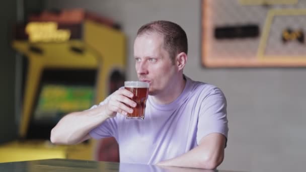Jovem bebendo cerveja um bar — Vídeo de Stock